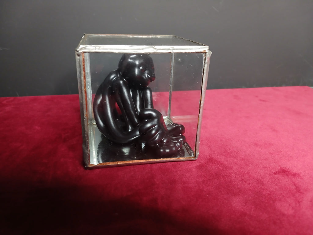 Petite sculpture noire au fini brillant représentant un chat assis